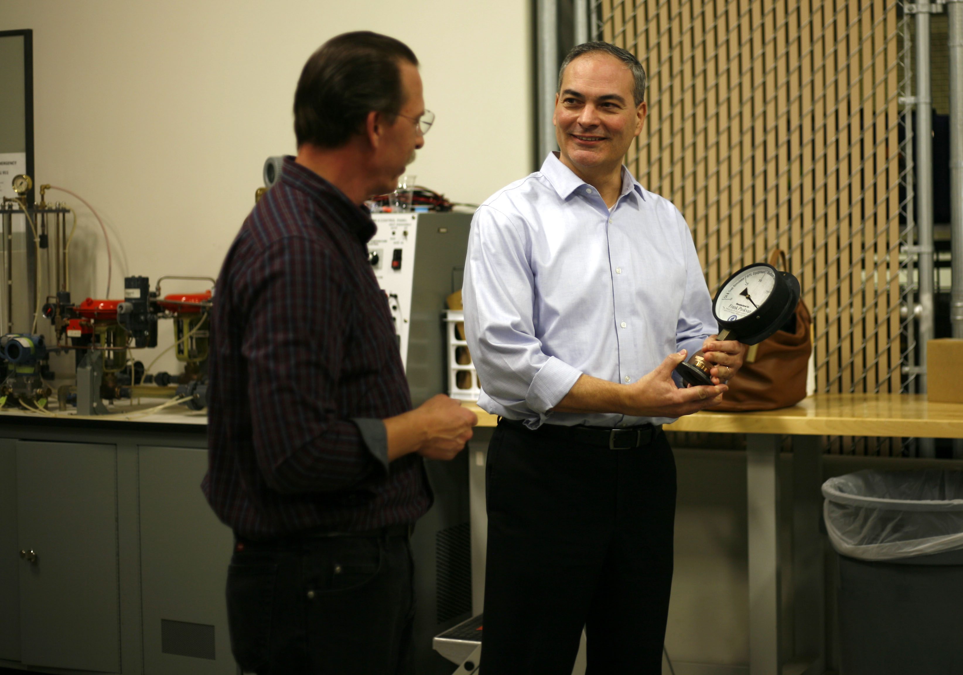 Frank Paskvan receives a pressure gauge “gift” from Brian Ellingson at the UAF Community and Technical College Process Technology Facility off Van Horn Road. Photo courtesy of Elizabeth Talbot.