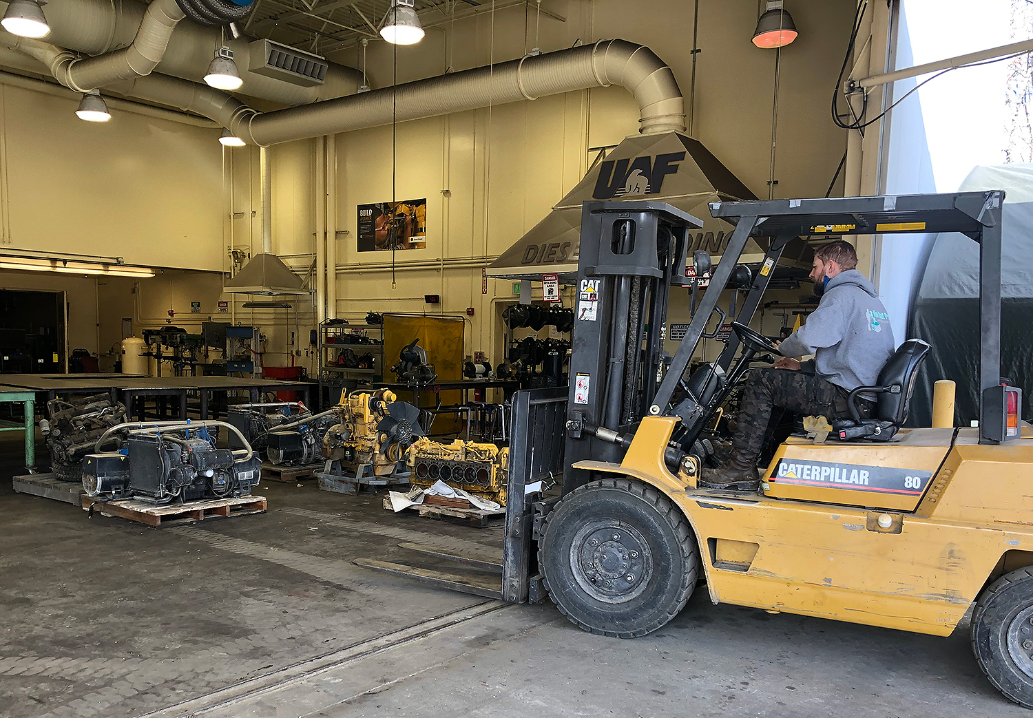 Forklift moving donated engine parts to shop.