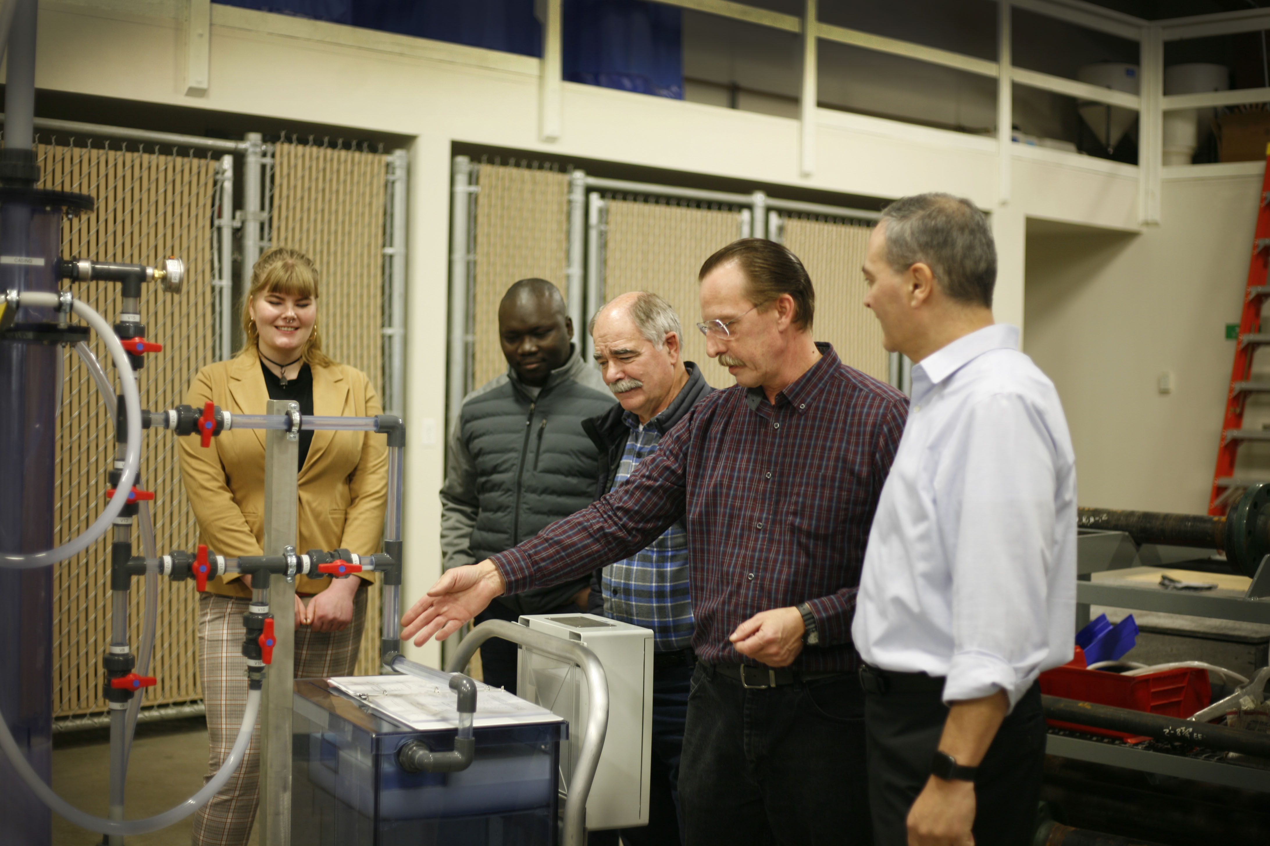 Brian Ellingson demonstrates testing equipment for Frank Paskvan, students and guests at the UAF Community and Technical College Process Technology Facility. The equipment gives students hands-on experience. Photo courtesy of Elizabeth Talbot.