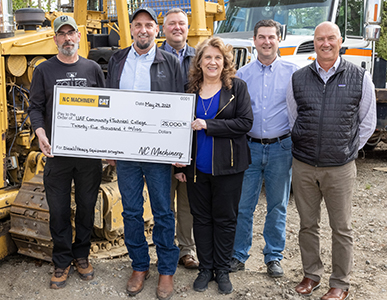 CTC accepts a $25,000 donation from NC Machinery for the diesel-heavy equipment program on May 24, 2023. From left are CTC assistant professor and program advisor Ray Ludwig, Brian  Saitta of NC Machinery, Chet Bennett of NC Machinery, CTC Dean Emeritus Michele Stalder, CTC Associate Dean Keith Swarner, and Rick Norman of NC Machinery. UAF photo by Eric Engman.