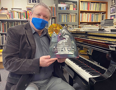 Denise Thorsen holding corner of check.