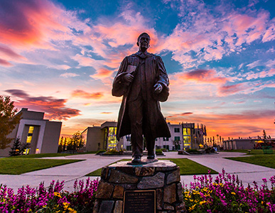 A beautiful sunrise casts upon the Bunnell statue greeting students and employees as they arrive on campus.
