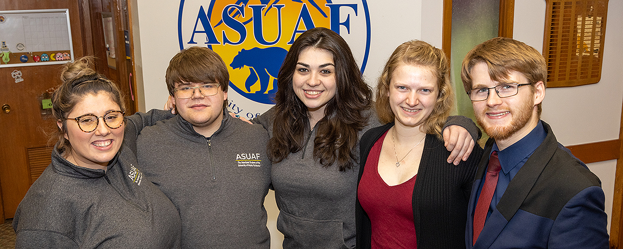 The five students pose together in the ASUAF office