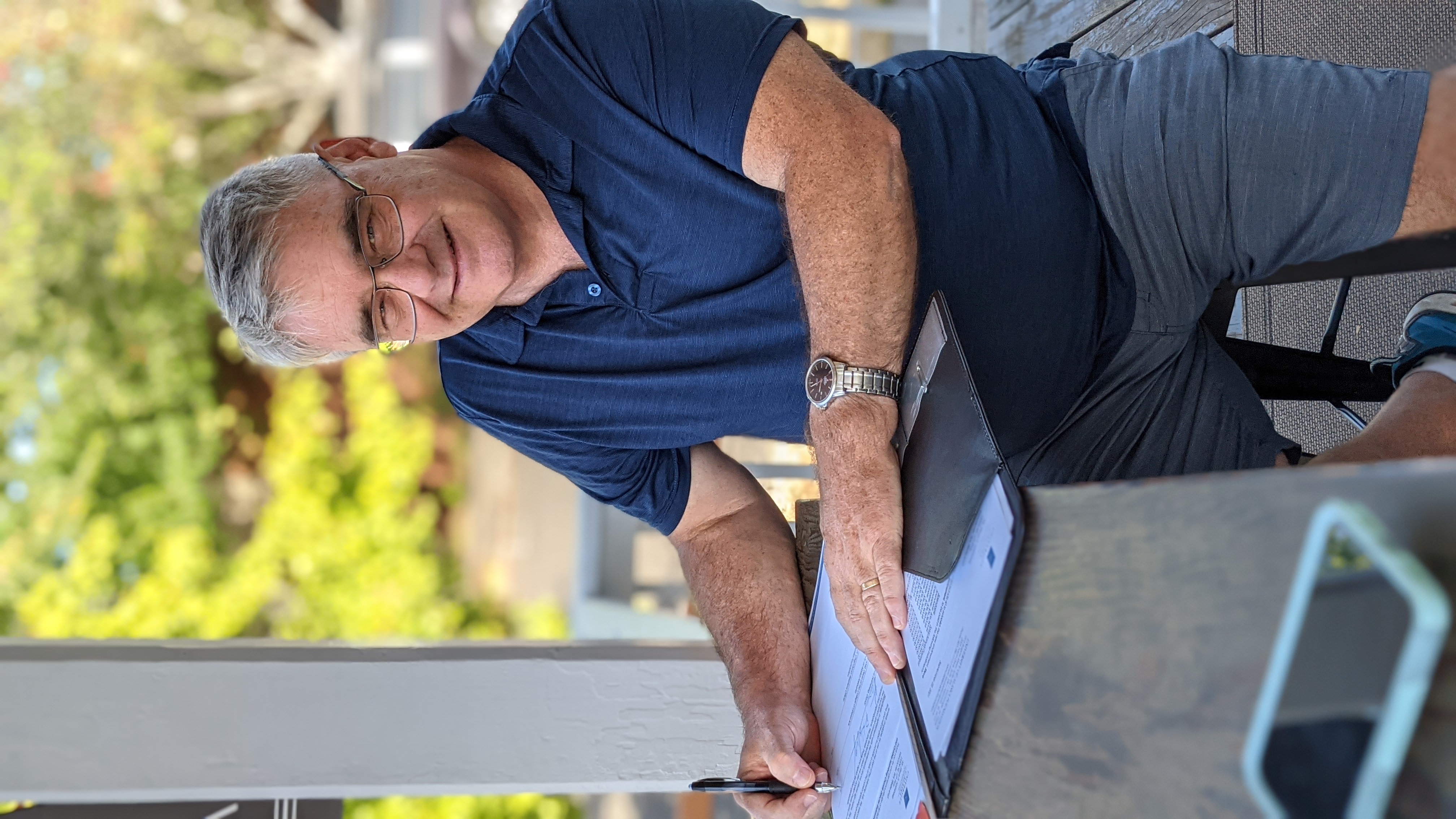 Steve Holmberg signs an agreement with the UA Foundation on Sept. 23, 2021, in Camas, Washington. The agreement outlines how he will fund the Steve and Cynthia Holmberg Choral Director Endowment during the coming decade. UAF photo by Megan Bean.