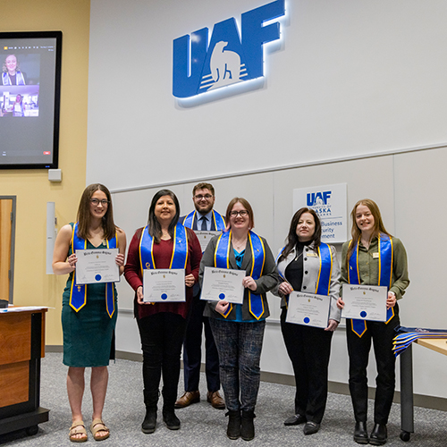 CBSM Honors student receive their pin and sash as they're inducted into the Order of Sword and Shield and Betta Gamma Sigma.