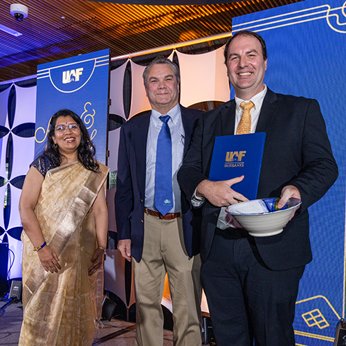 Brandon Boylan, political science professor and director of the Arctic and Northern studies program in the College of Liberal Arts, received the Emil Usibelli Distinguished Teaching Award at the Blue and Gold Banquet and Fundraising Auction at Dine 49 on the UAF campus Saturday, September 14, 2024. Former Provost and Executive Vice Chancellor Anupma Prakash, left, and Joe Usibelli Jr., center.