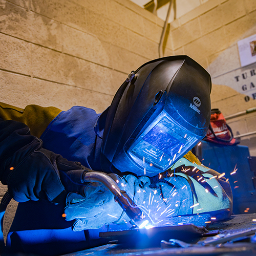 UAF CTC students enrolled in the Welding and Materials Technology course work on various projects and industry standard practices in the Hutchison Center as they earn their welding certification over the course of two semesters in the Hutchison Center, Nov.12, 2024. UAF photo by Leif Van Cise.