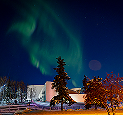 Aurora borealis in the sky above campus. Links to Gifts by Estate Note.