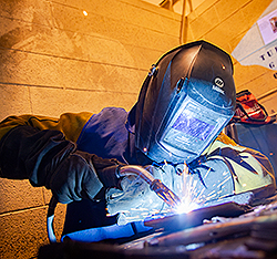 A UAF CTC student welding. Gifts That Pay You Income.