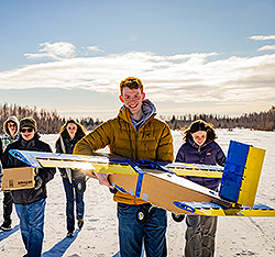 A group of students out testing a model plane. Links to Gifts That Protect Your Assets