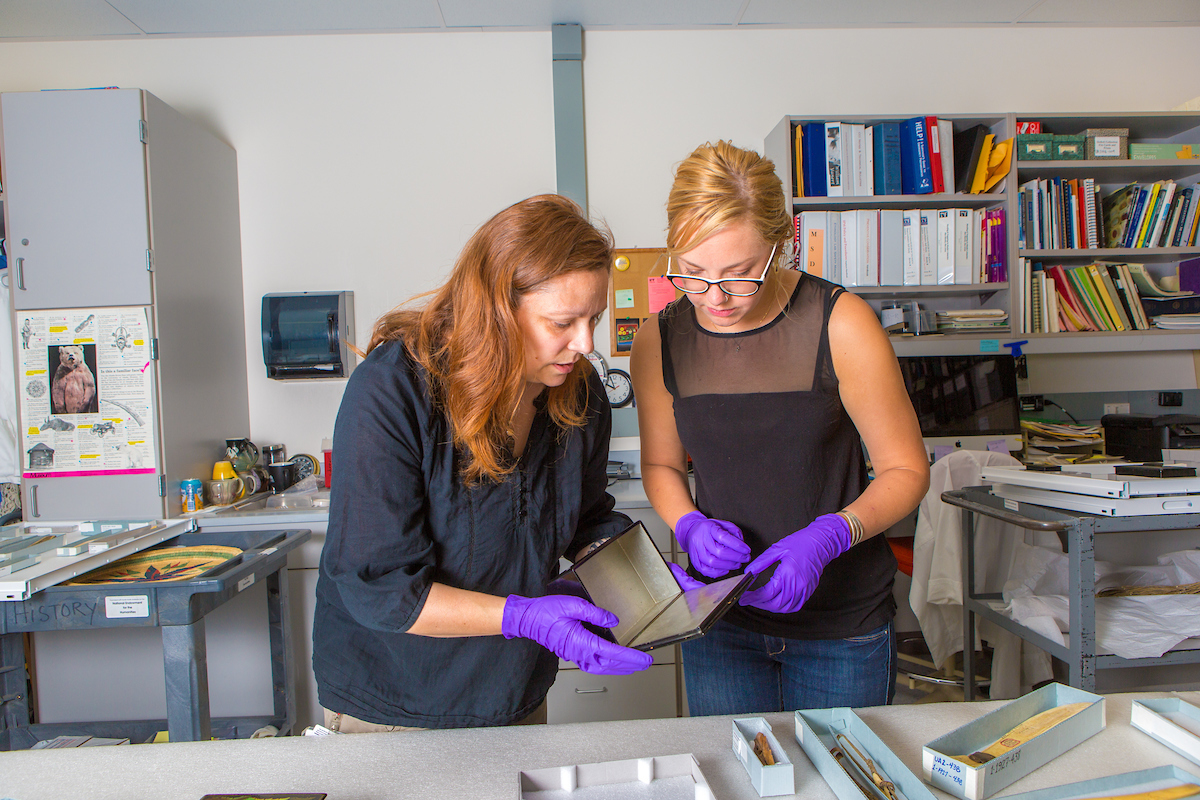Angela Linn, left, ethnology and history collections manager at the University of Alaska Museum of the North, catalogs donated Russian artifacts with student assistant Kirsten Olson in a museum lab. | UAF Photo by Todd Paris