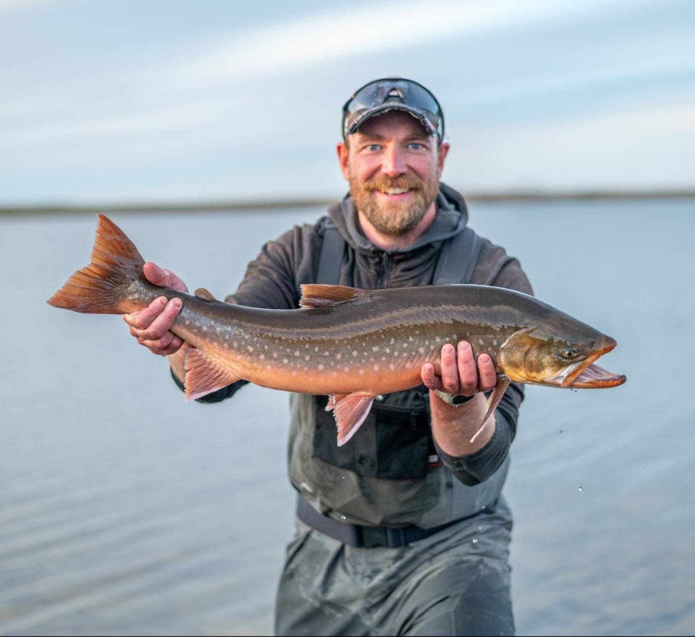 Researcher Matt Gilbert holds an Arctic char.