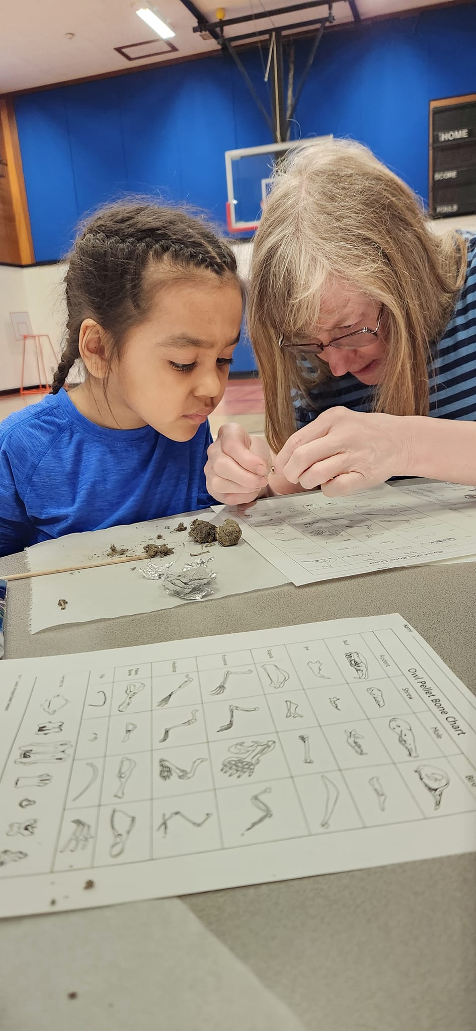 Youth working on craft with teacher