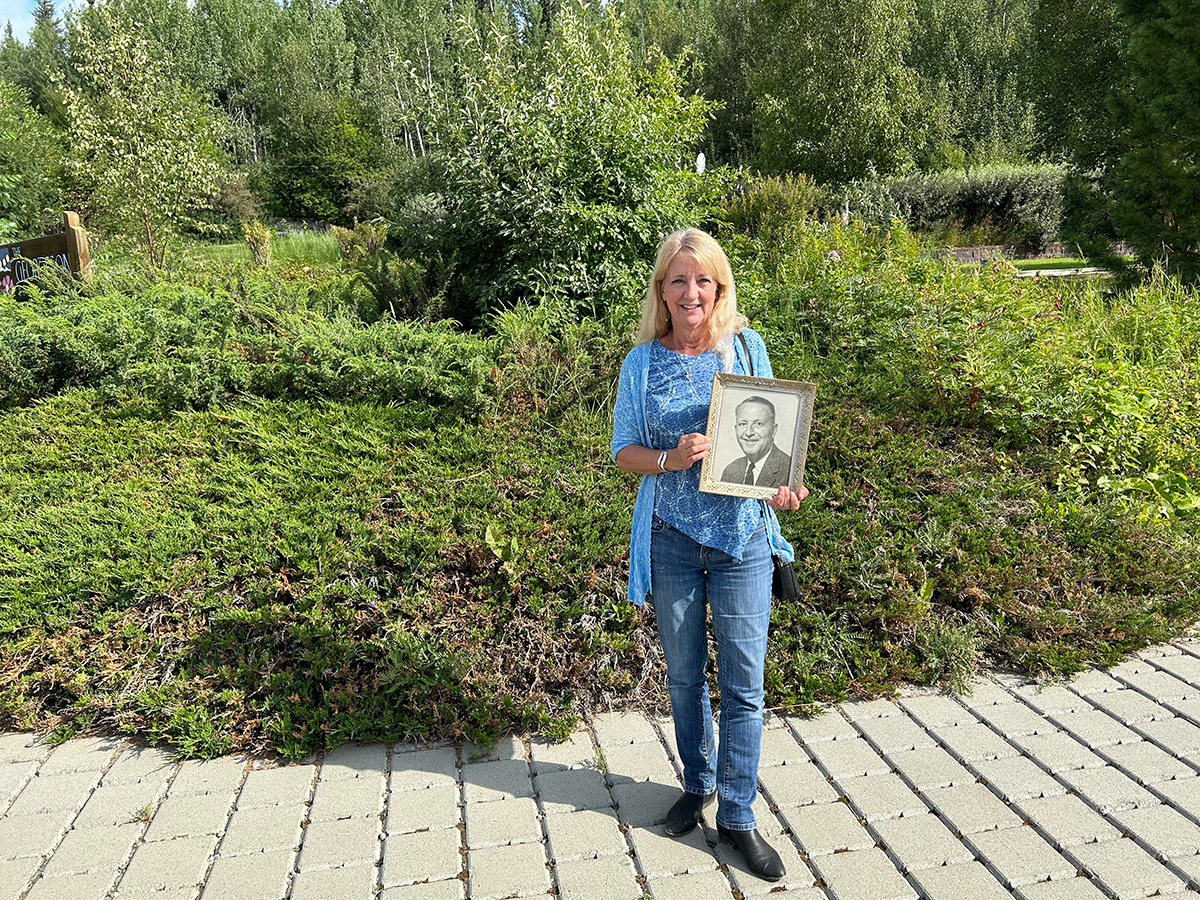Woman smiling holding a photograph