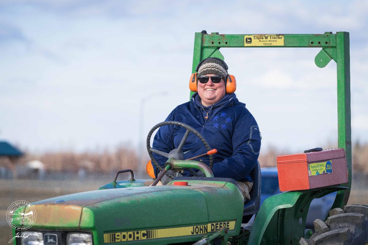 Woman driving tractor