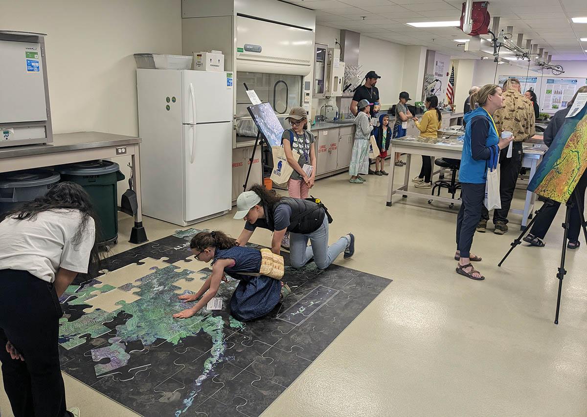 Group looking at large map displayed on the floor