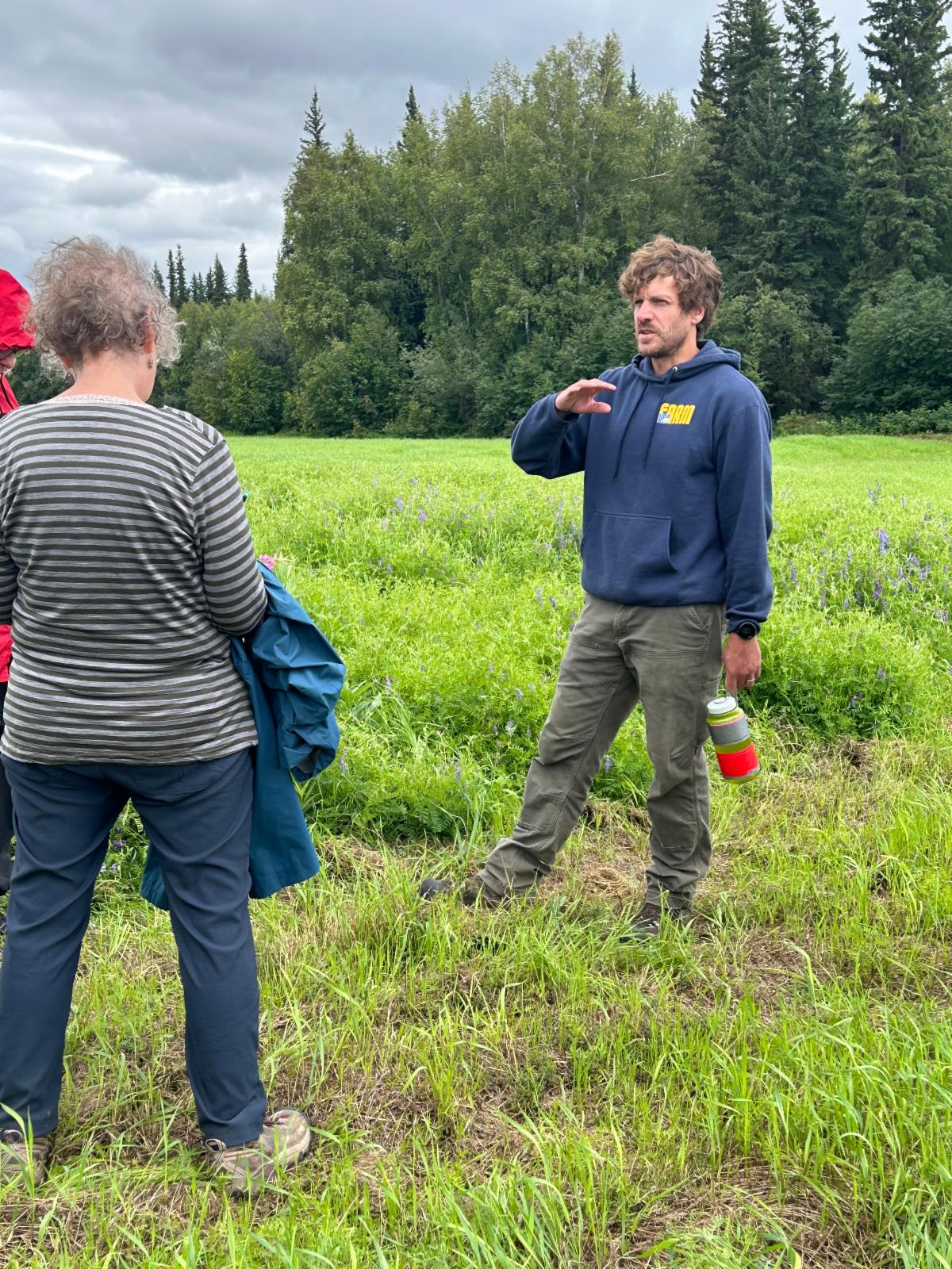 Two people standing in a field