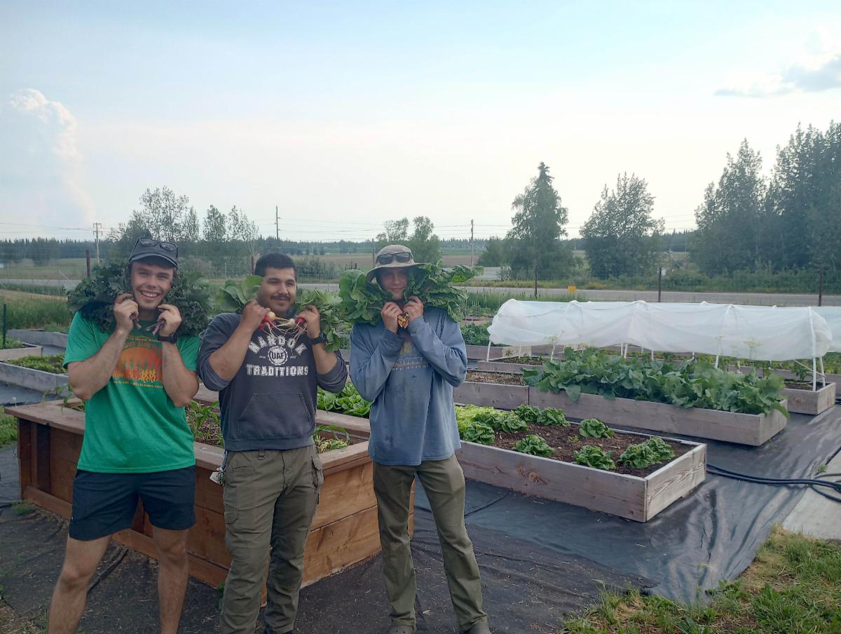Three people smiling and posing for a photo
