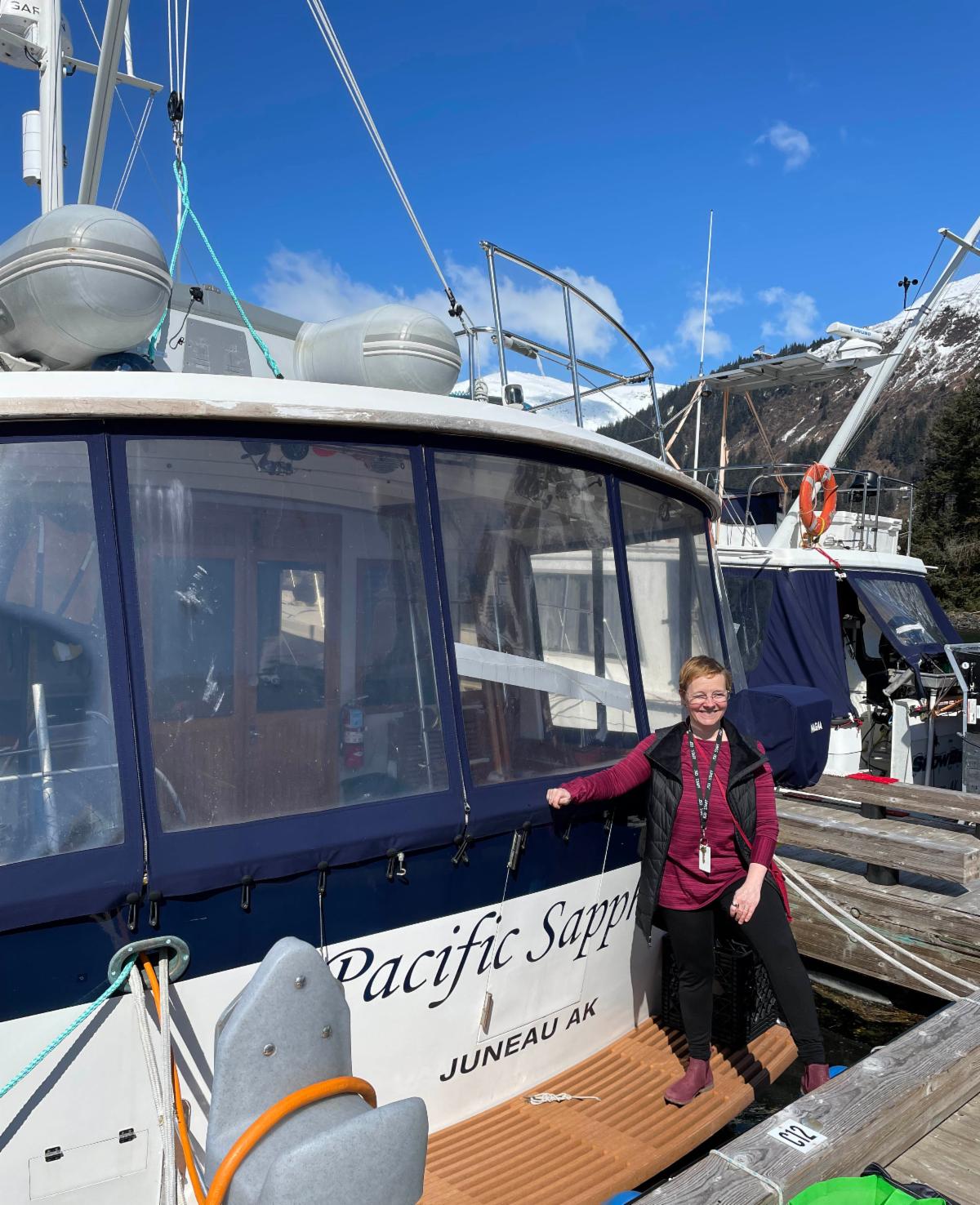 Woman standing beside a boat