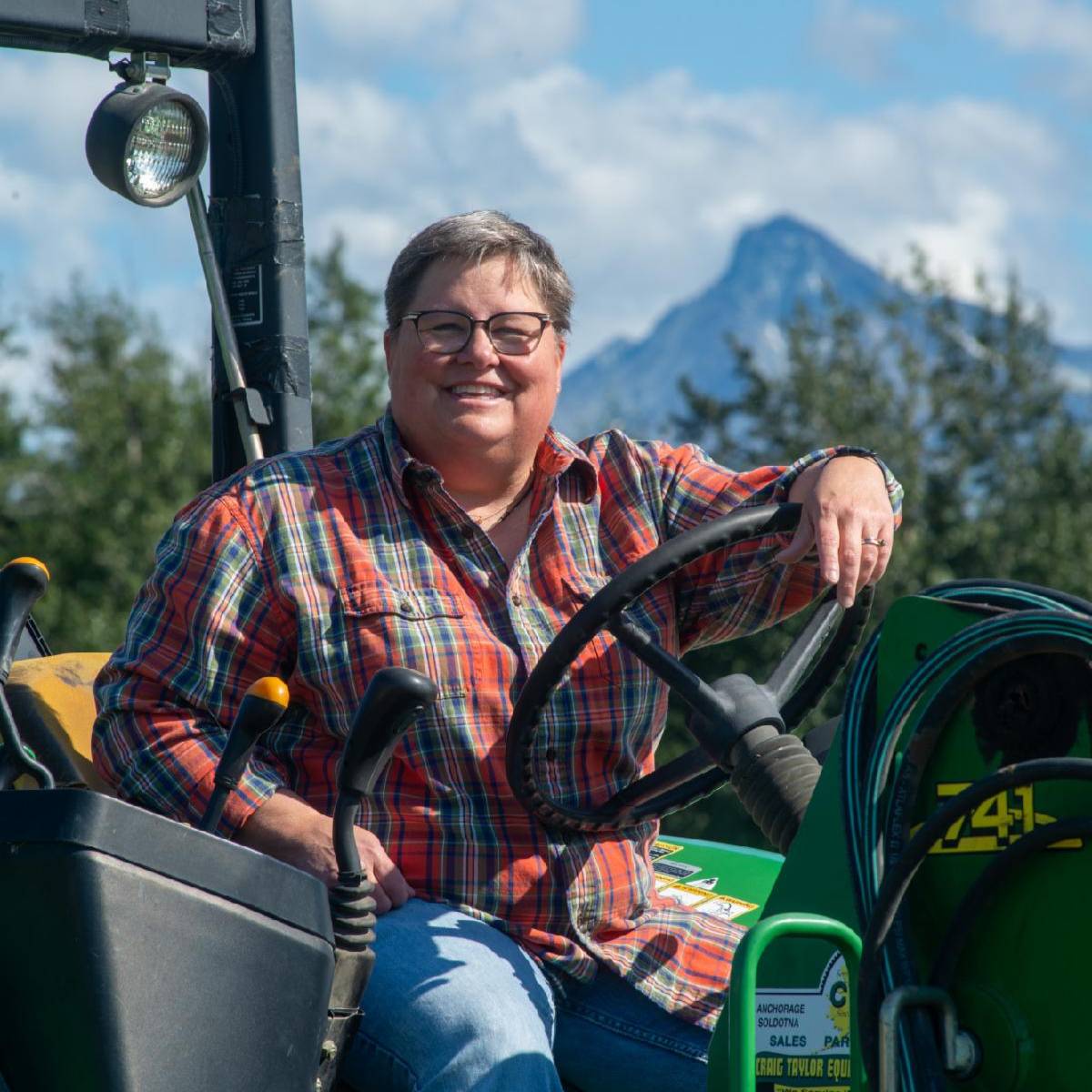 Woman driving tractor