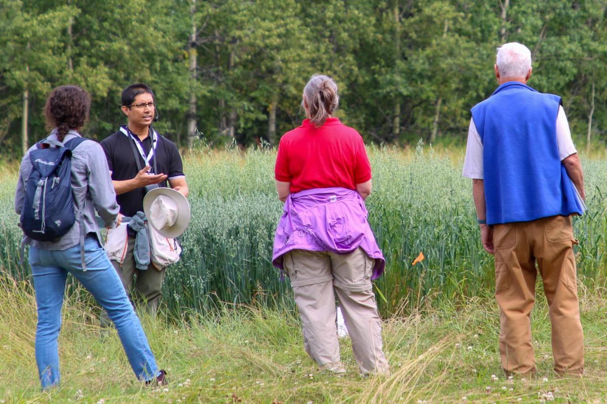 Group of people standing by grain