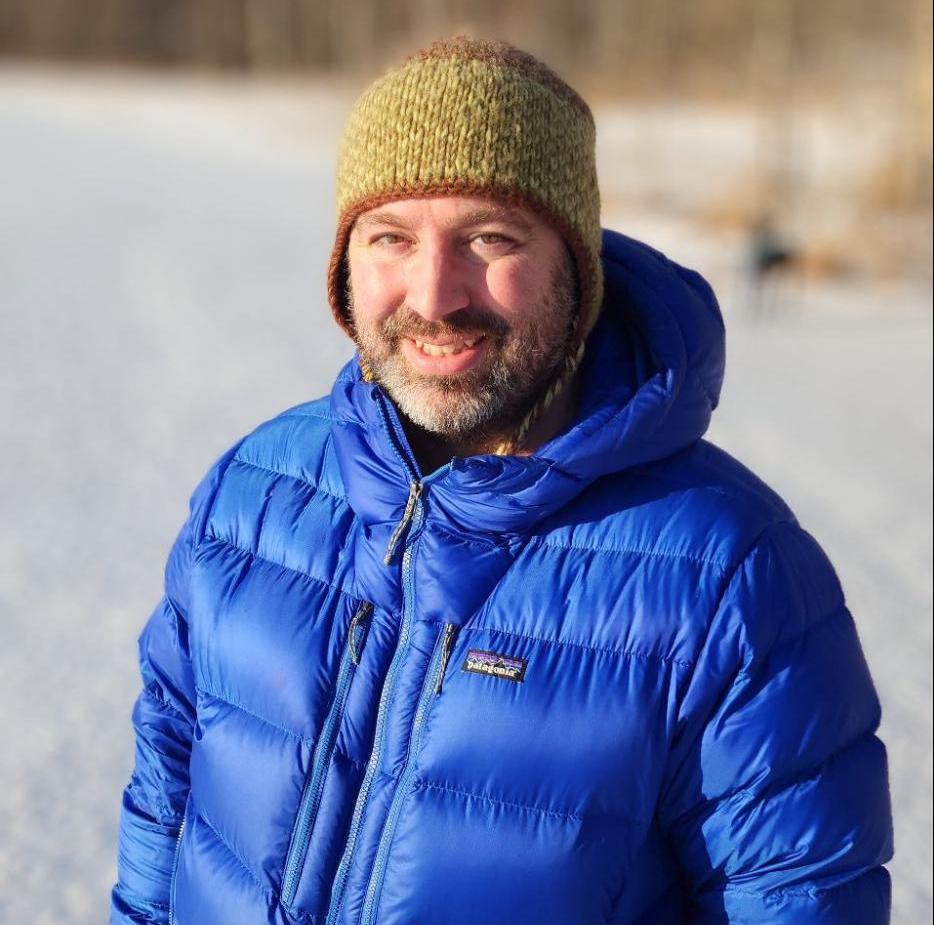 Man smiling in blue jacket
