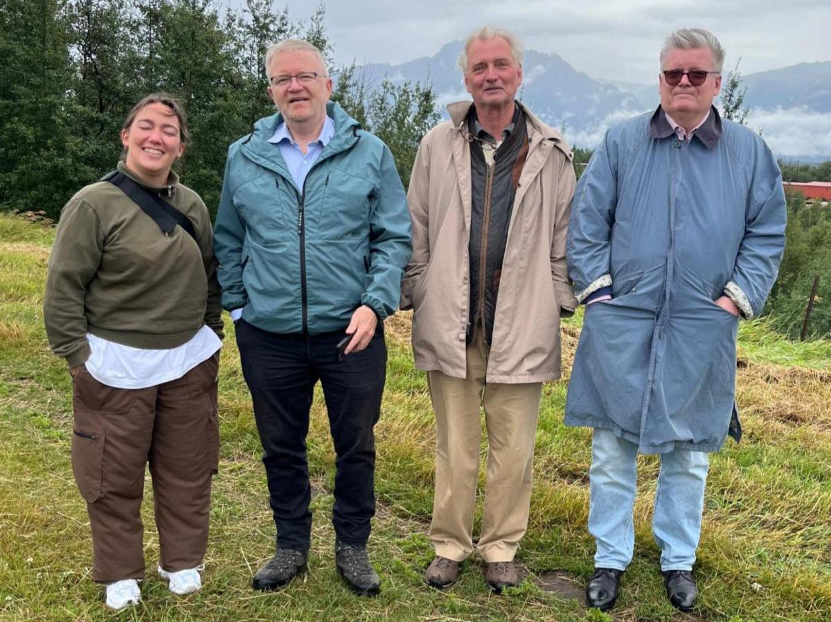 Four people smiling posing for photo