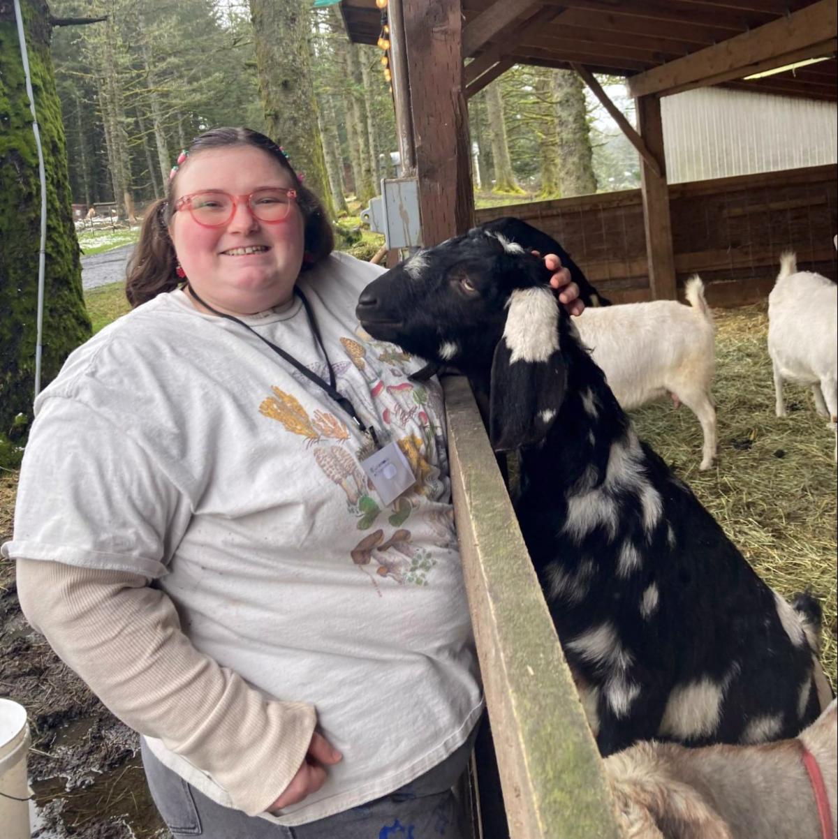 NextGen scholar Cam Piciaccia meets a goat at a Kodiak farm