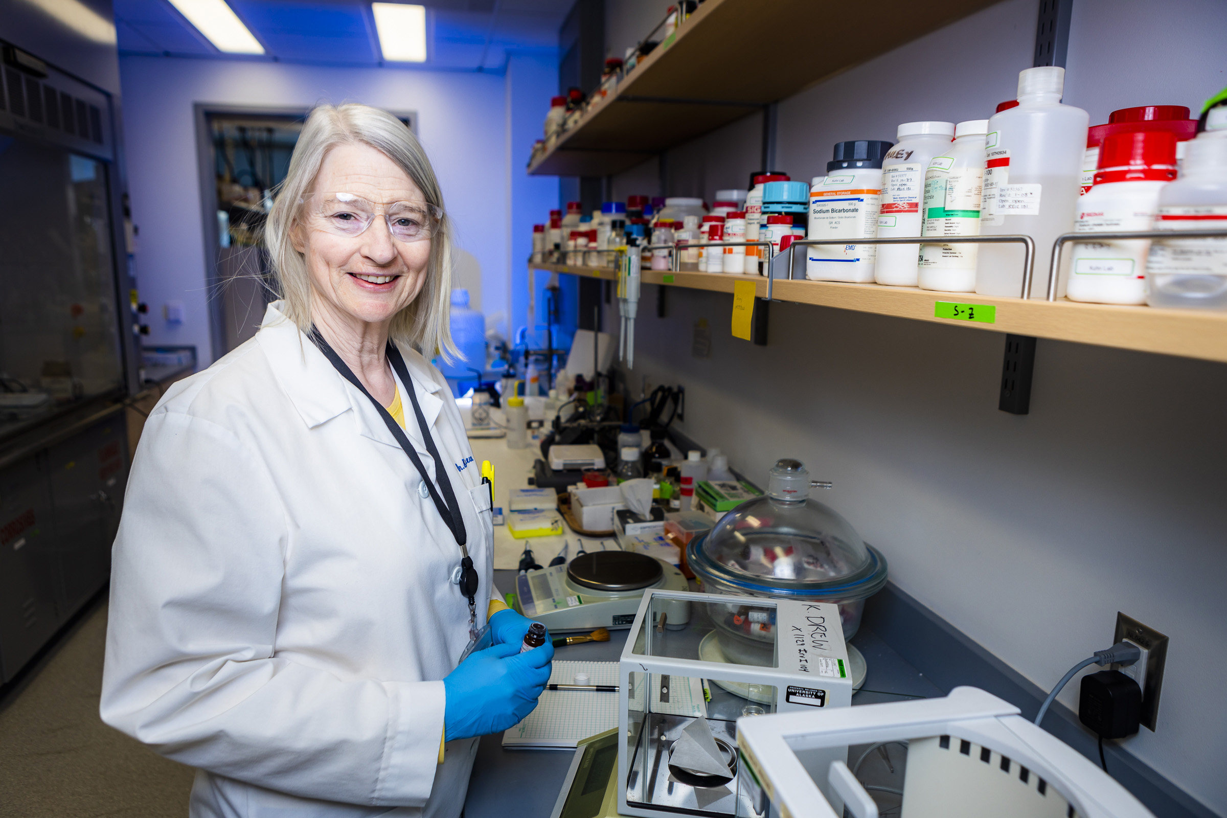 Kelly Drew stands in her lab. Photo by JR Ancheta.