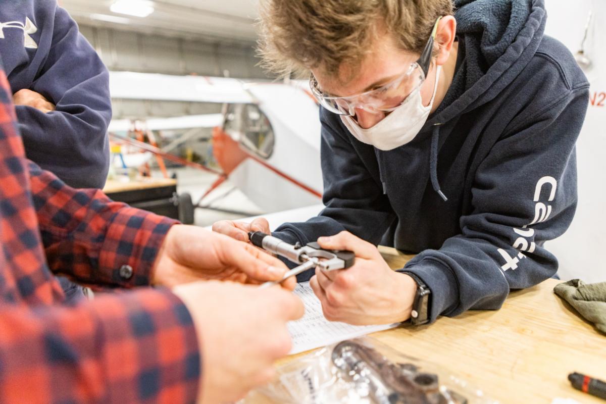 A student tinkers with some equipment 