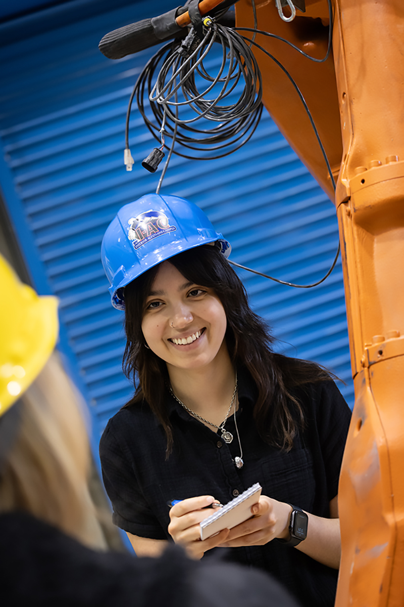 Journalism Students at Work A journalism student in a hard hat interviews a worker. UAF Photo by Charles Mason
