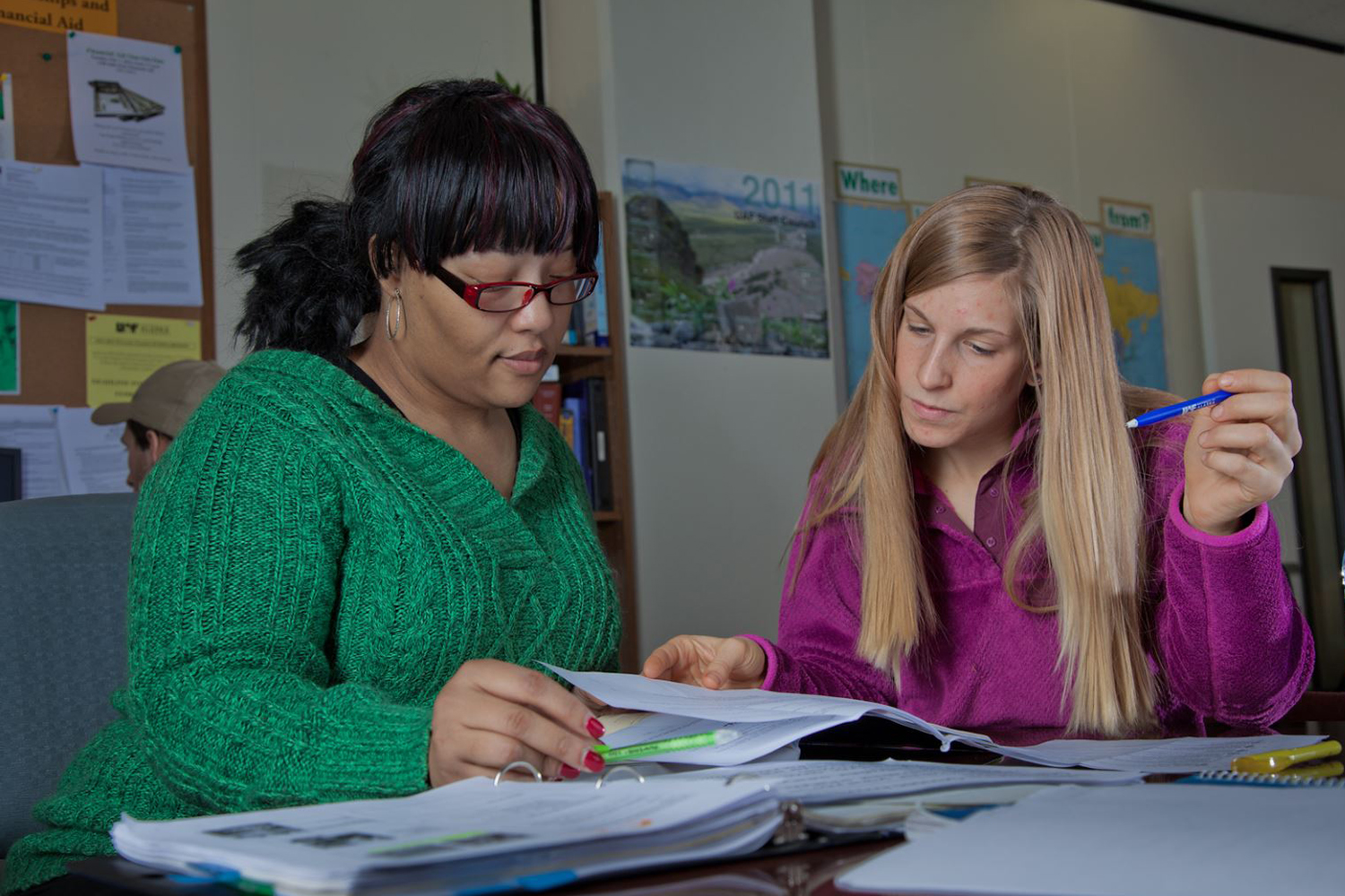 A tutor works with a student 