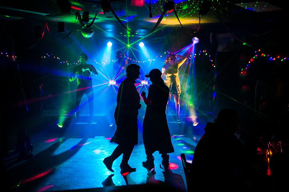 Students dance to the music during the UAF Pub's Pride Night event at the Fairbanks campus.