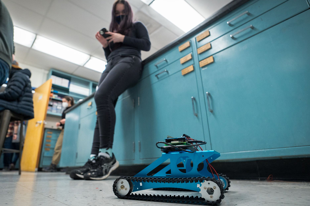 Student driving a robot
