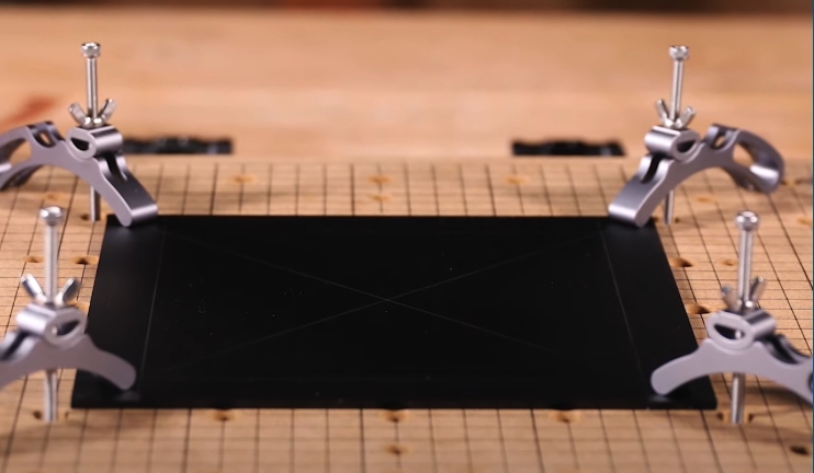 Showing how to clamp down project on to the deck of the 3-axis CNC machine