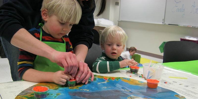 Children with playdoh & global map