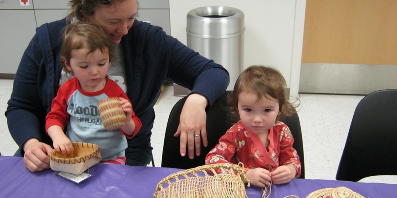 Children and parent examine baskets