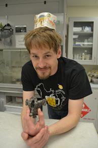 Eric Metz holding a thalattosaur vertebra (back bone).