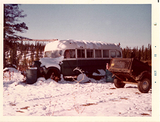 photo of a bus in the snow with a truck trailer