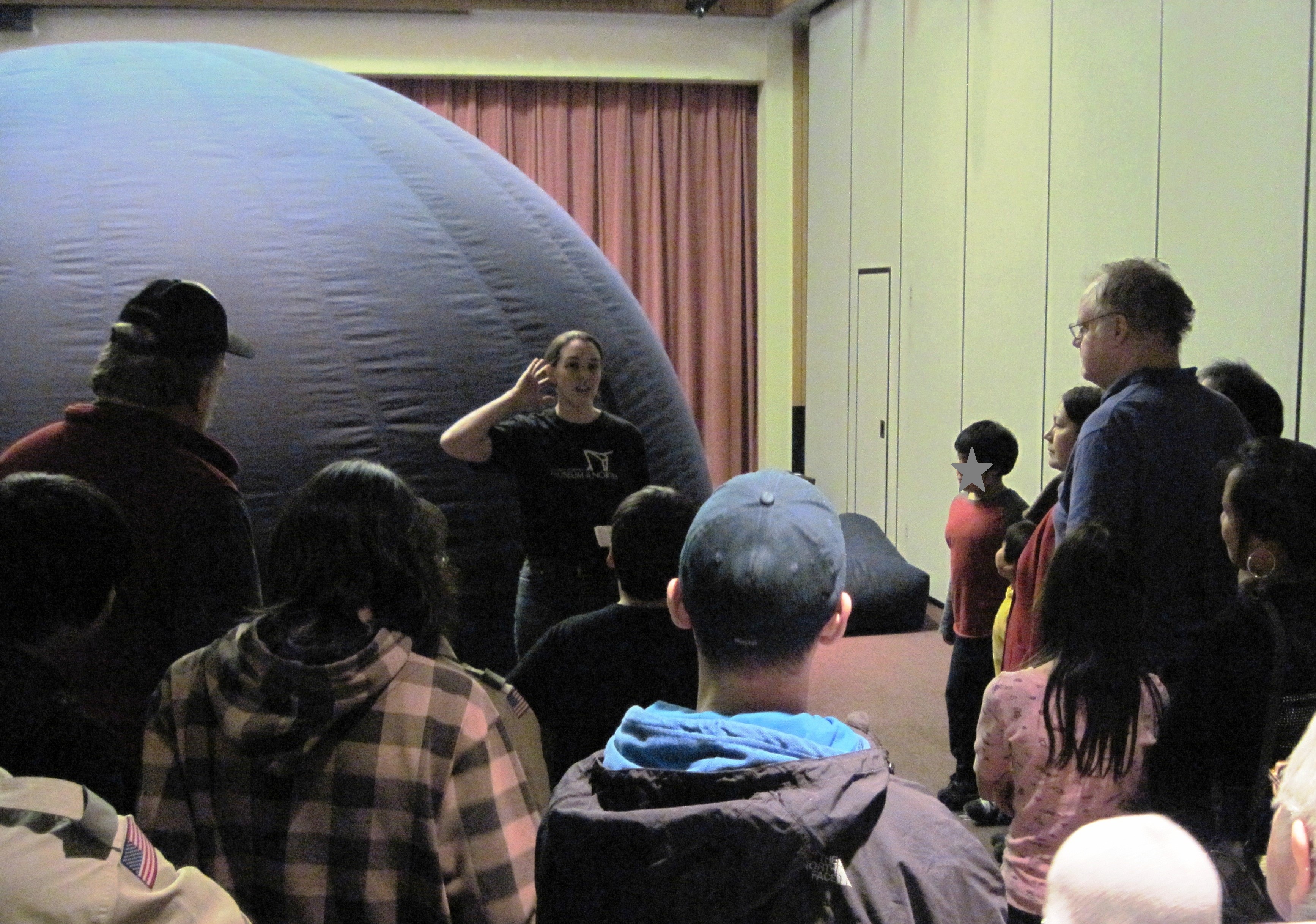 Museum educator with portable planetarium in Bethel, Alaska.