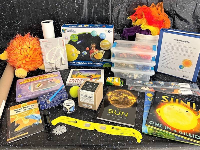 Sun Discovery kit contents on starry background.