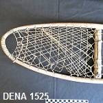 Close-up of front part of snowshoe, showing the sinew webbing. The background is black. 