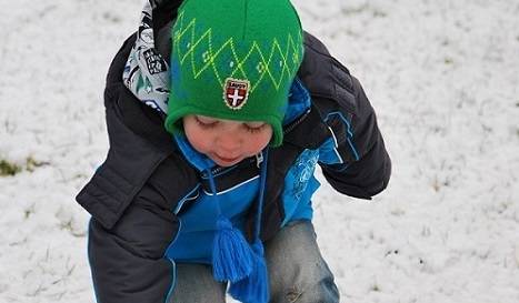 A child explores in the snow.
