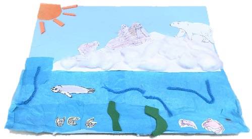 Collage of a sea ice habitat, made with tissue paper, yarn, and foam pieces. 