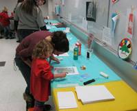 Child and adult making art at Early Explorers.