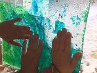 Children playing with a homemade light box.