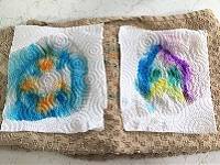 Two paper towel pieces, decorated with markers.