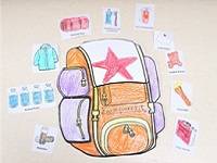 Paper backpack colored with crayon, surrounded by cutouts of various objects.