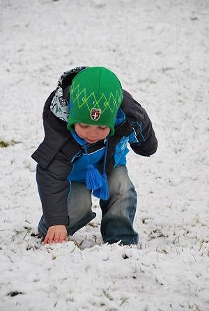 A child explores in snow.