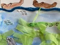 Kelp forest collage example with a blue ocean, blue yarn, green tissue paper, and colored cutouts of sea otters.